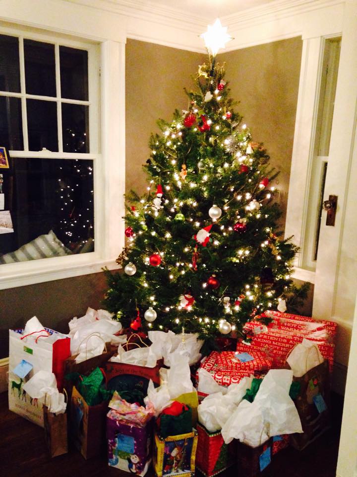 Mrs. Claus Project gifts under a Christmas tree.