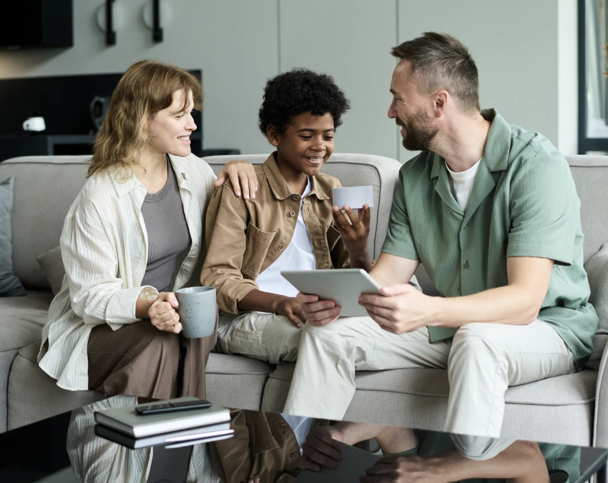 adults conversing looking at notepad