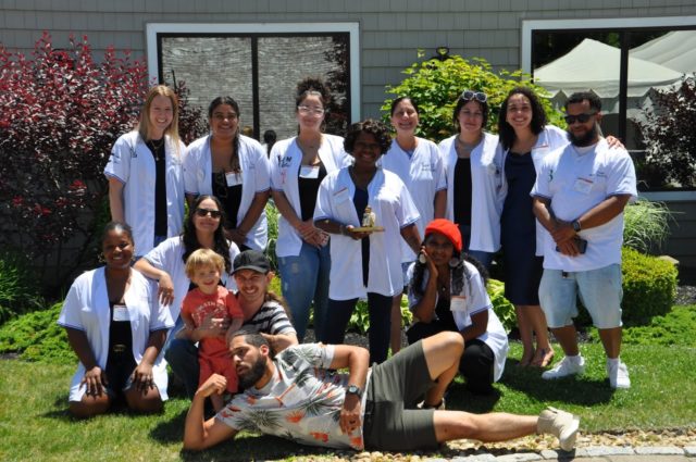 group of people posing outside smiling