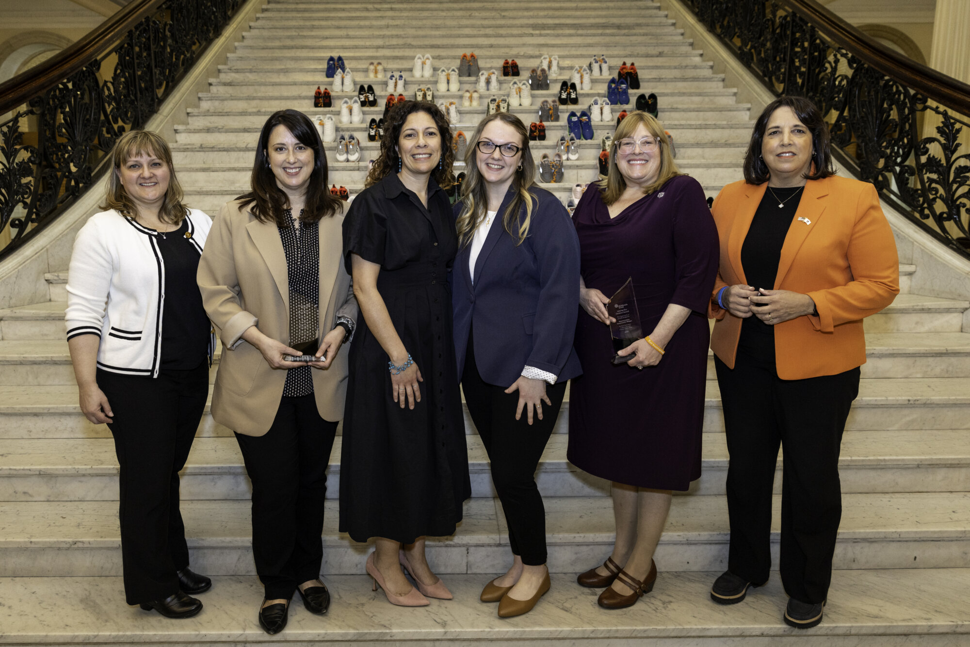 Leadership in front of the Grand Staircase at the Statehouse for Child Abuse Prevention Month.