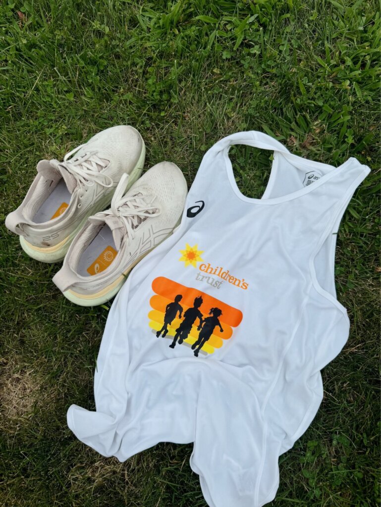 Running shoes and a Children's Trust branded running tank top.