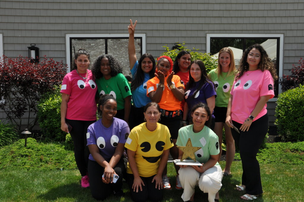 Group of attendees wearing colorful matching outfits