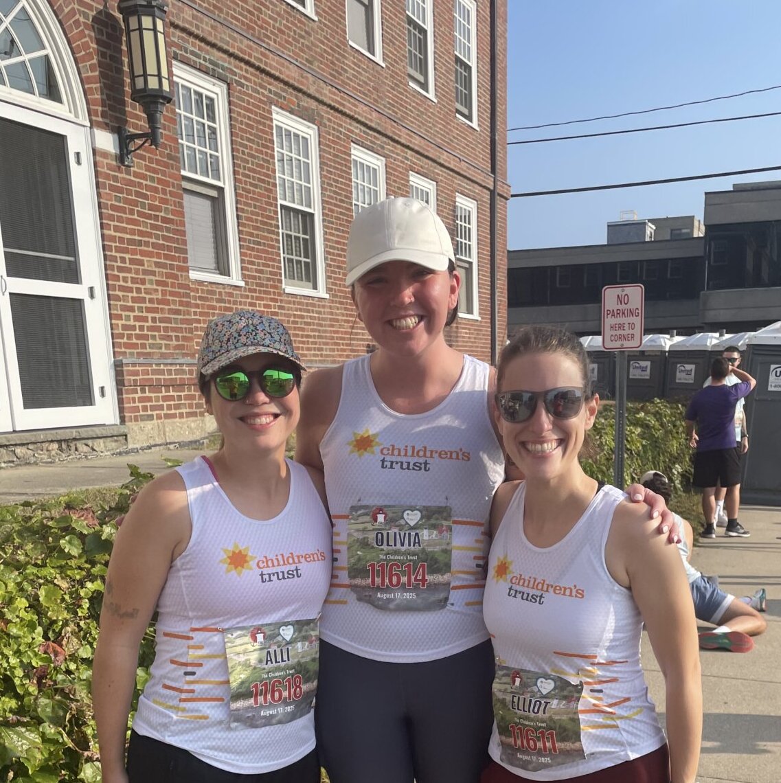 Three Children's Trust Falmouth Road Race Runners smiling.