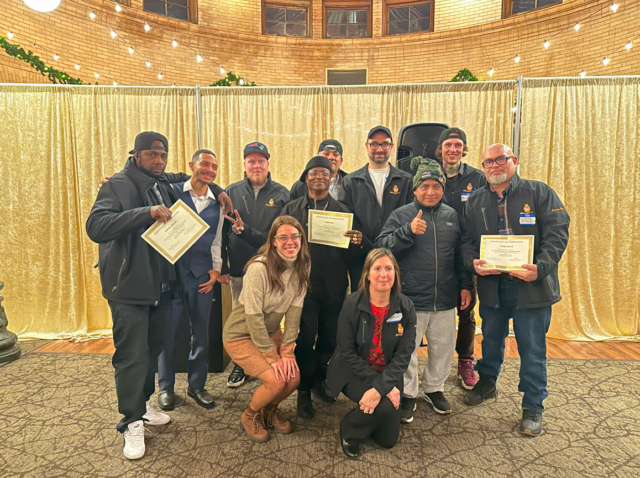 fathers posting with graduation certificates