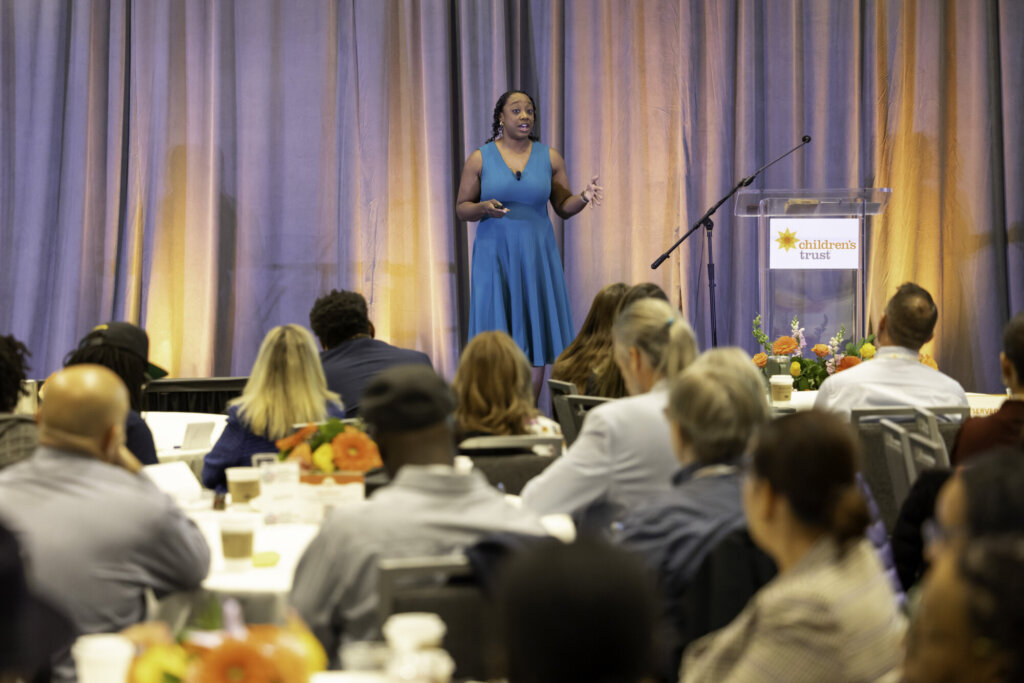 2025 A View from All Sides Keynote Speaker, speaking to attendees in the ballroom.