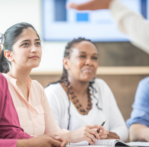 Colleagues attending a training, taking notes.