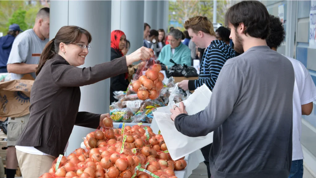 Photo of woman handing out onions