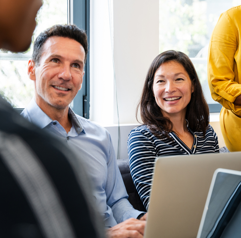 staff conversing at meeting