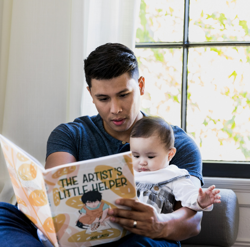 Dad reading to his child.