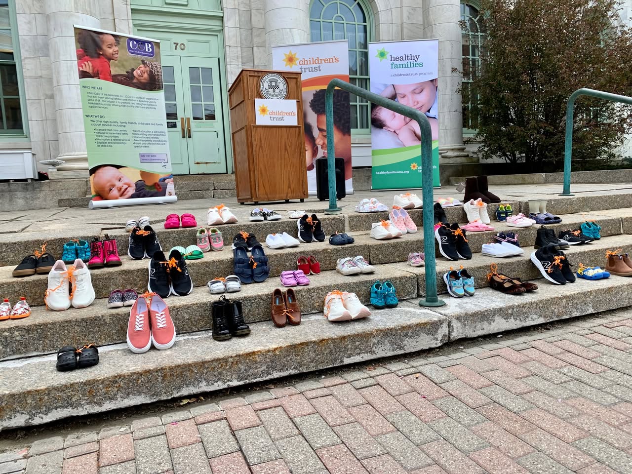 children's shoes displayed on stairs outside