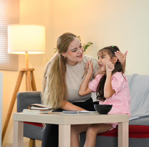 A woman and a child sitting on a couch.