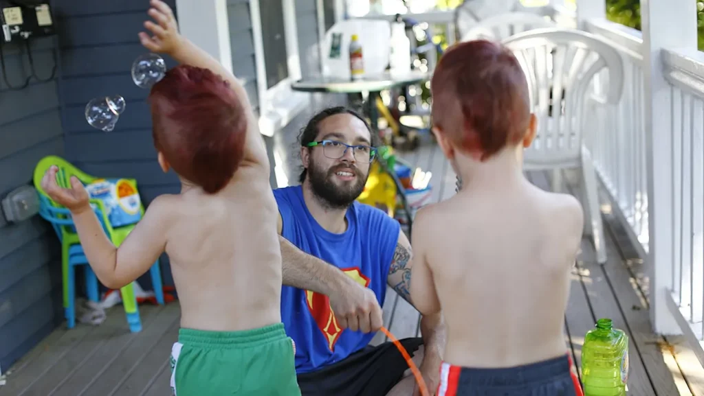 Kenny and his two kids playing outside