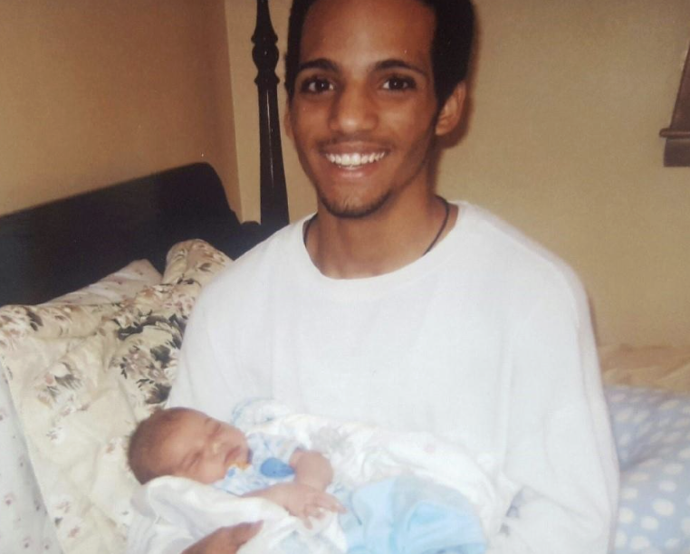 Norland holding his new born son