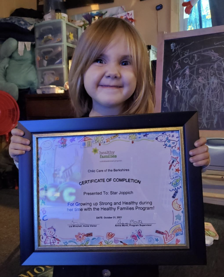Damien's Daughter Star smiling with a Healthy Families Certificate of Completion 